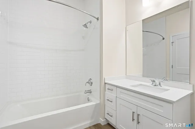 a bathroom with a toilet a sink and a mirror