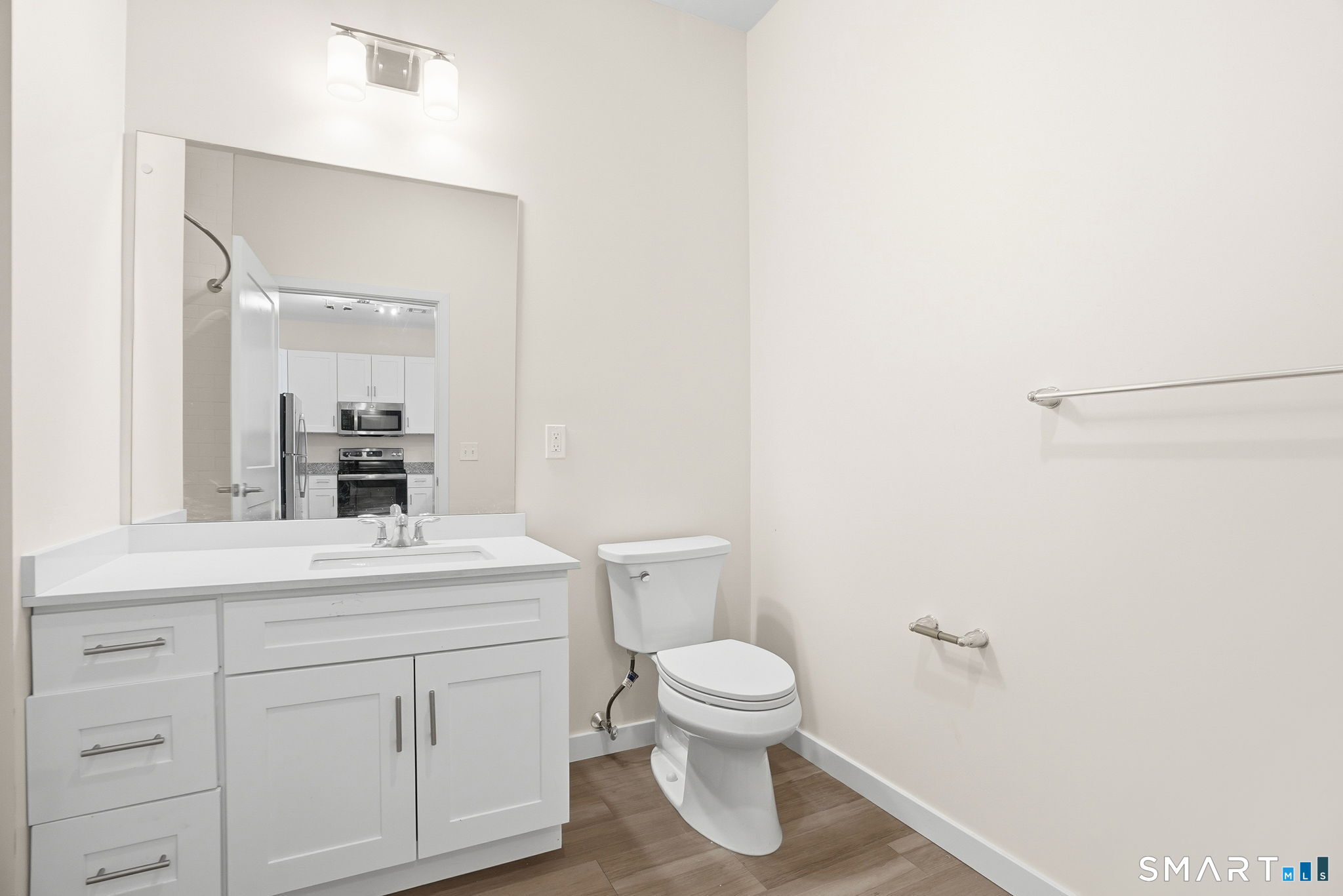71 Connecticut Avenue, Unit 206 Norwalk, CT 06850 - Photo 16 of 17 a bathroom with a toilet a sink and a mirror