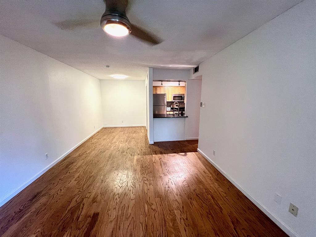4845 Cedar Springs Road, Unit 368 Dallas, TX 75219 - Photo 11 of 38 an empty room with wooden floor closet and windows