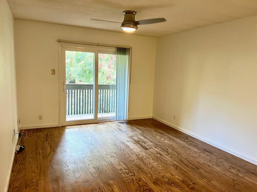 4845 Cedar Springs Road, Unit 368 Dallas, TX 75219 - Photo 13 of 38 a view of an empty room with wooden floor and a window