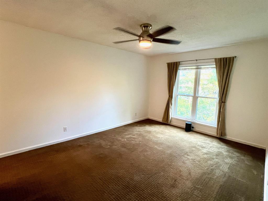 4845 Cedar Springs Road, Unit 368 Dallas, TX 75219 - Photo 17 of 38 an empty room with a window and a fan
