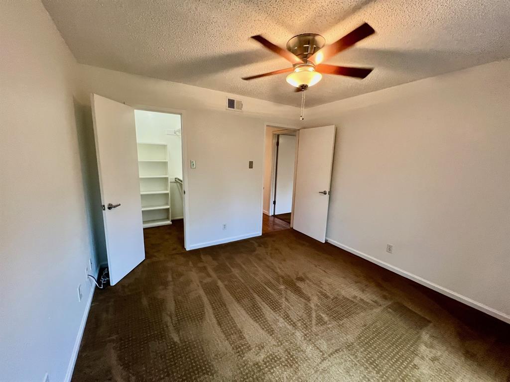 4845 Cedar Springs Road, Unit 368 Dallas, TX 75219 - Photo 24 of 38 an empty room with closet and a ceiling fan