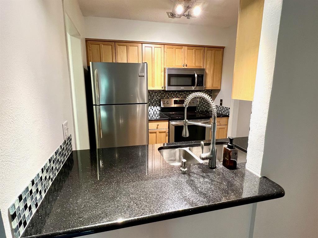4845 Cedar Springs Road, Unit 368 Dallas, TX 75219 - Photo 6 of 38 a kitchen with a refrigerator sink and stove