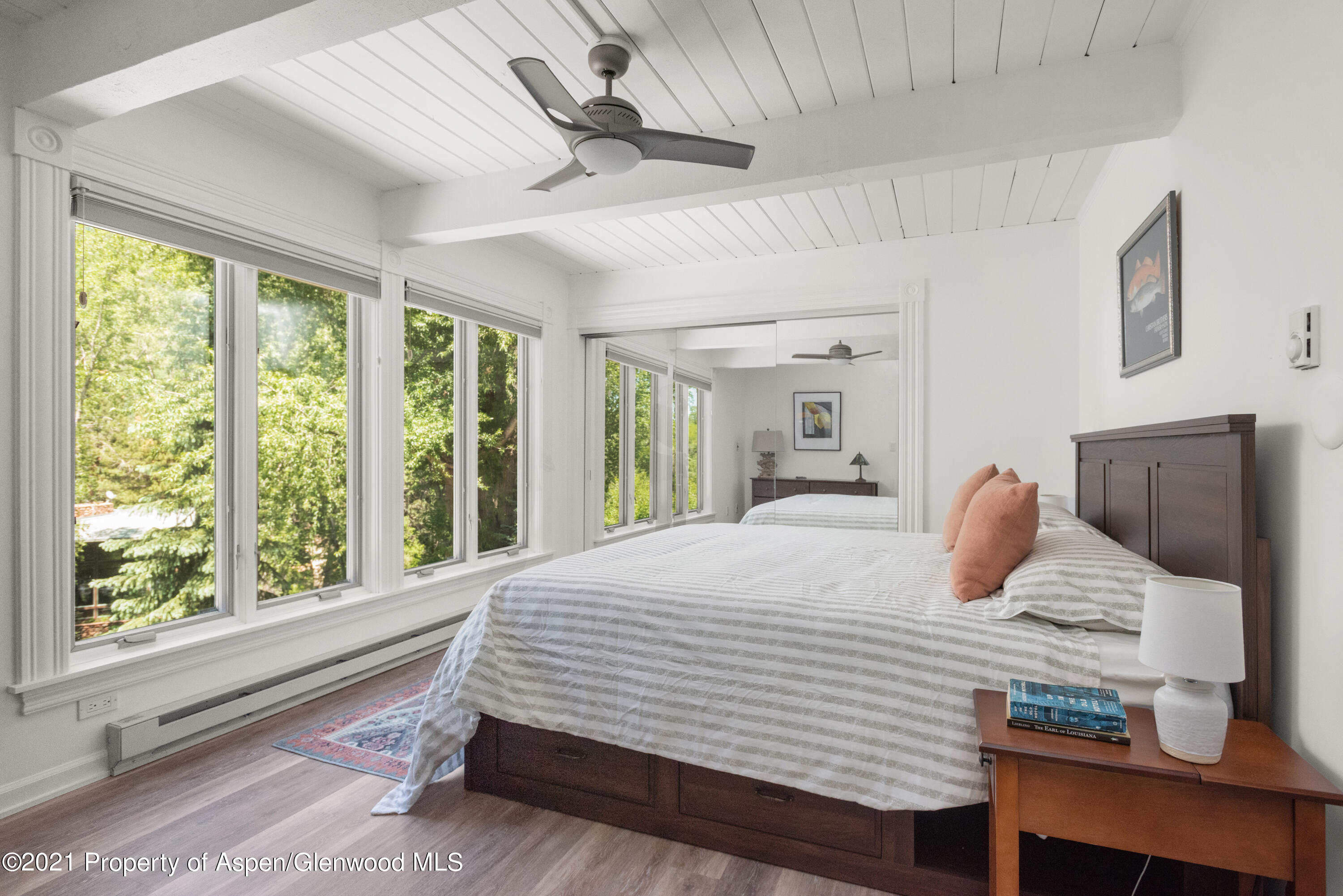 916 East Hopkins Avenue, Unit 204 Aspen, CO 81611 - Photo 5 of 14 a bedroom with a large bed and wooden floor