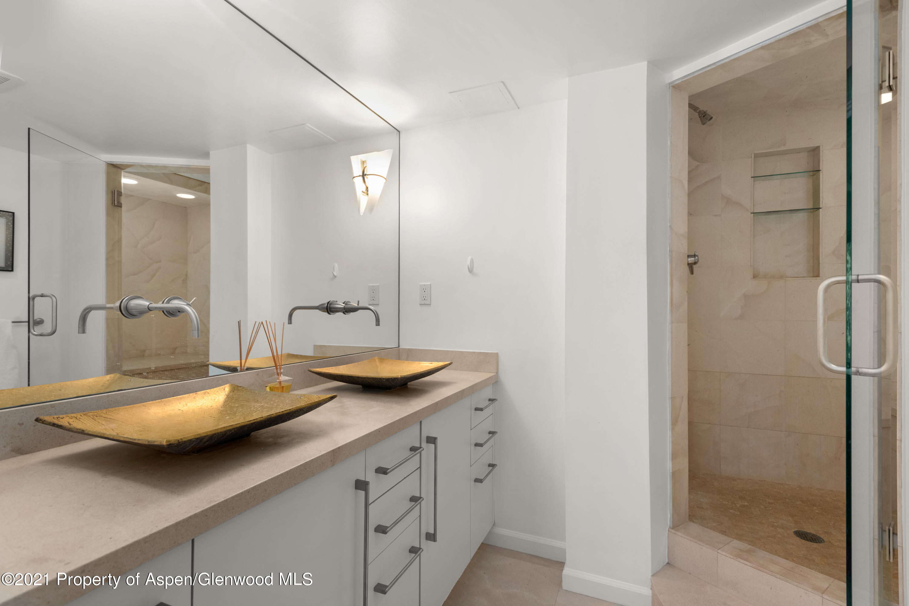 916 East Hopkins Avenue, Unit 204 Aspen, CO 81611 - Photo 7 of 14 a bathroom with a double vanity sink and mirror with shower