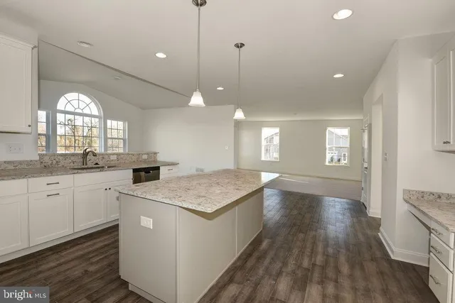 a kitchen with sink stove and refrigerator