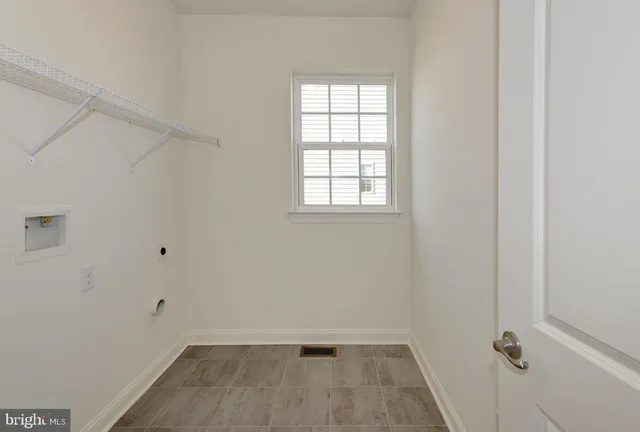 an empty room with a empty space and windows