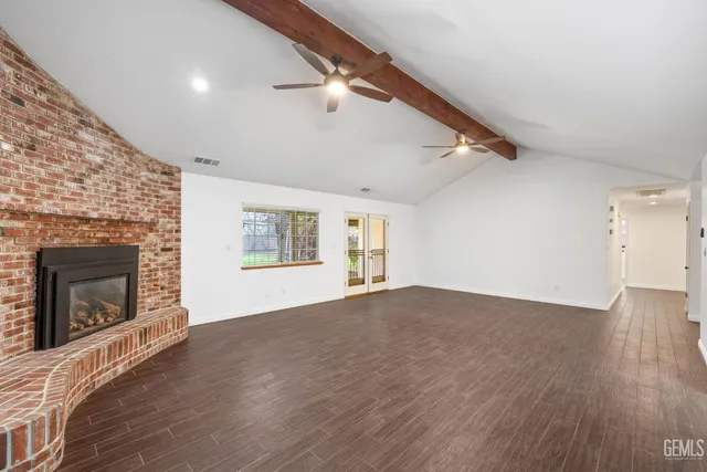 a kitchen with kitchen island white cabinets and window