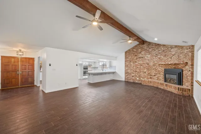 a kitchen with kitchen island a sink appliances and cabinets