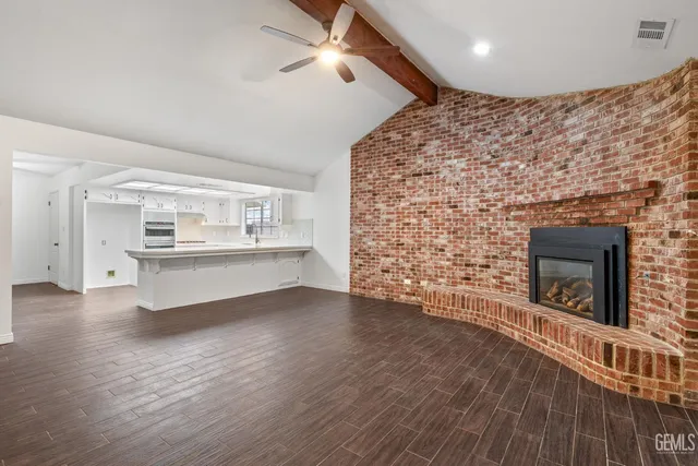 a large white kitchen with a large window
