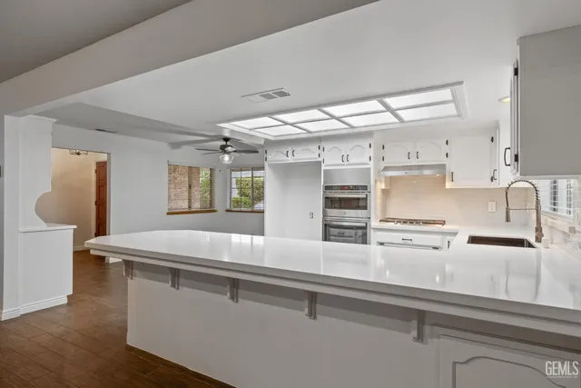 a kitchen with cabinets a sink and appliances