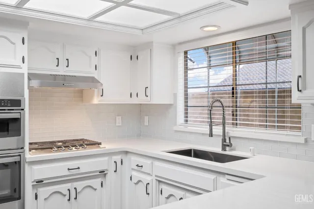 a hallway with cabinets and wooden floor