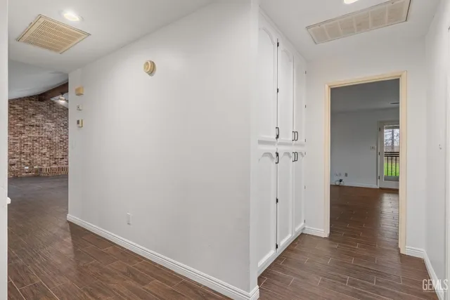 a spacious bathroom with a double vanity sink a toilet and a shower