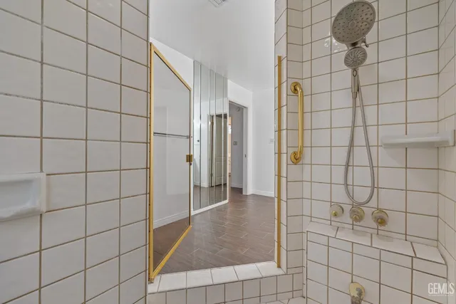 a bathroom with a double vanity sink mirror and next to a window
