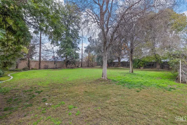 an aerial view of residential houses with outdoor space and parking