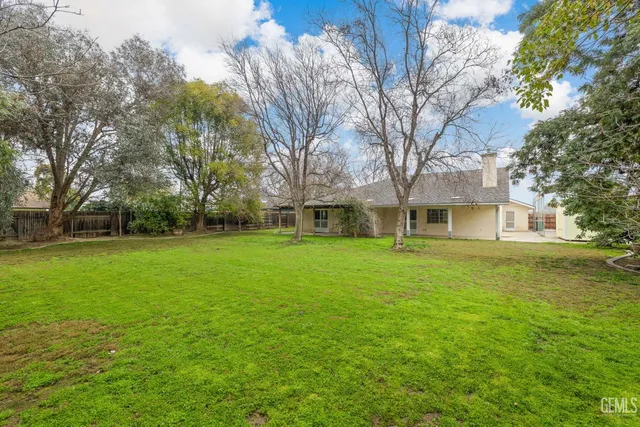 an aerial view of a house with yard