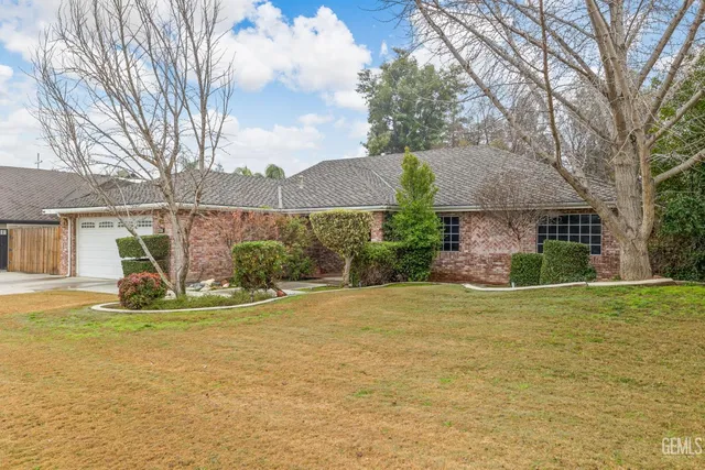 wooden floor fireplace and windows in an empty room
