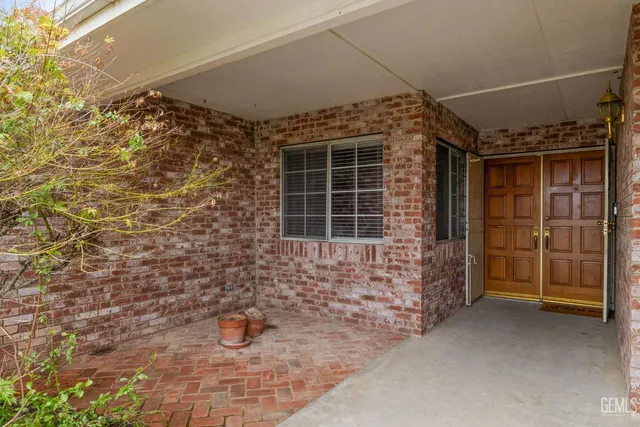 a view of empty room with wooden floor and fireplace