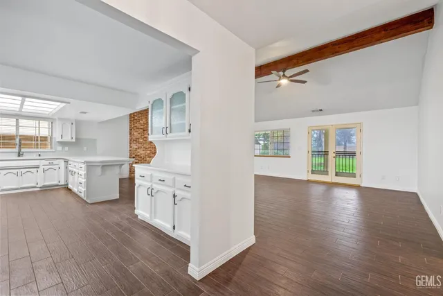 a view of empty room with wooden floor and fireplace
