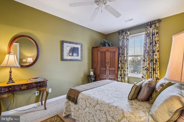 a bedroom with a bed dresser and a window