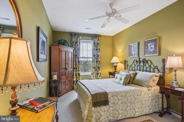 a bedroom with a bed and a painting on the wall