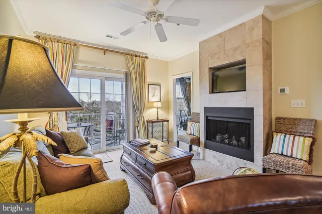 a living room with furniture and a ceiling fan