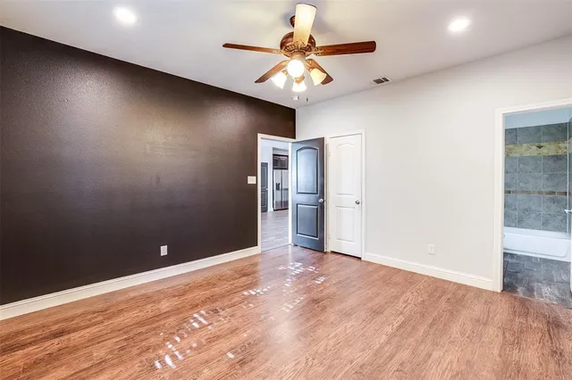 a bathroom with a granite countertop sink toilet mirror and shower