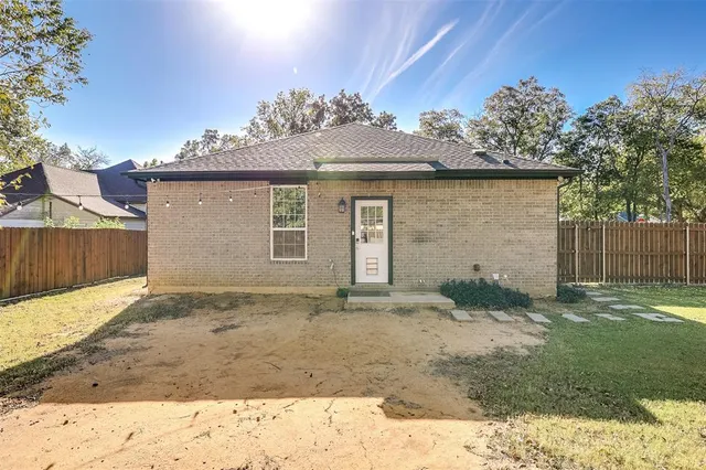 a bathroom with a granite countertop sink toilet mirror and shower
