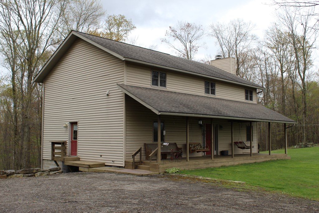 410 Line Road Knox, PA 16232 - Photo 20 of 42 a front view of a house with sitting area and garden