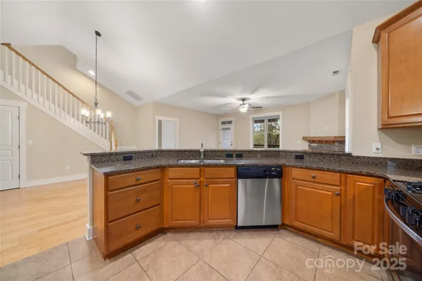 a kitchen with stainless steel appliances granite countertop a sink and cabinets