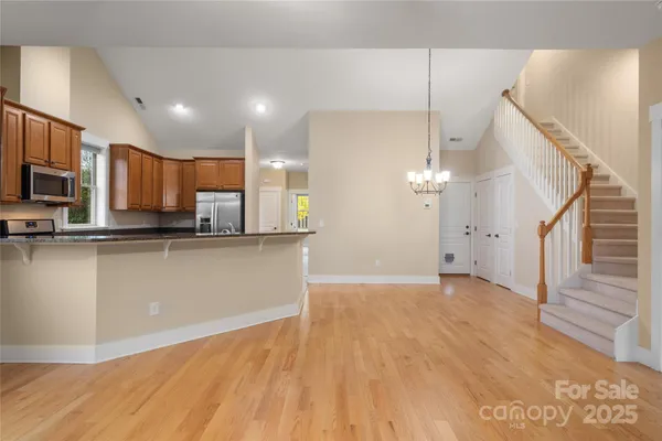 a view of a kitchen with a sink a microwave and cabinets