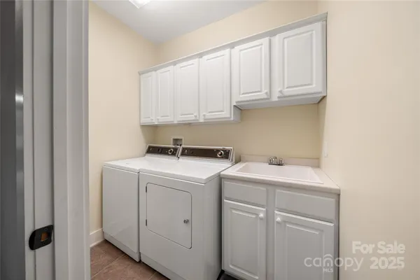 a view of a storage and utility room with washer and dryer