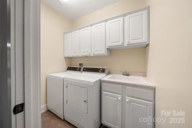 a view of a storage and utility room with washer and dryer