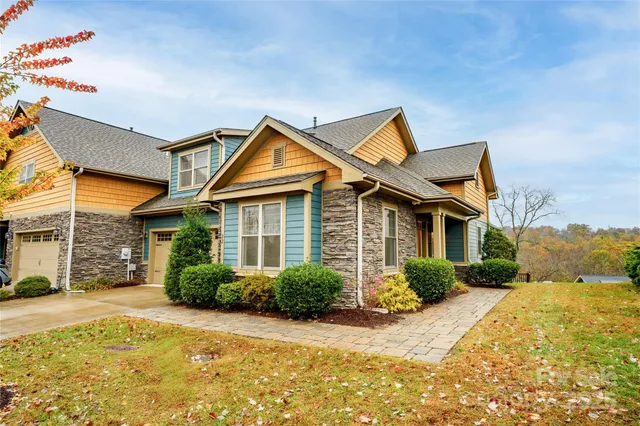 an aerial view of a house with a yard and lake view