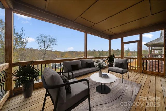 a balcony with wooden floor and outdoor seating