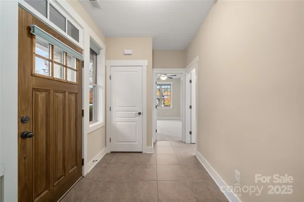 an entryway with a cabinet and a door