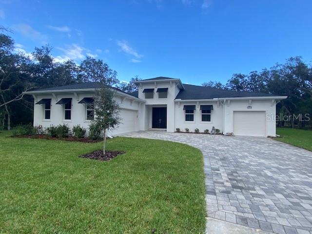 12954 Marabou Drive Spring Hill, FL 34610 - Photo 1 of 1 a front view of house with a garden