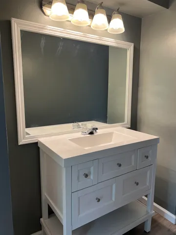 a bathroom with a sink and a mirror