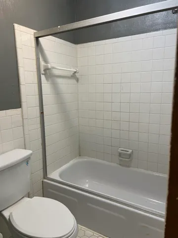 a view of an empty room with window and closet area