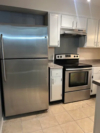 a stove top oven sitting inside of a kitchen