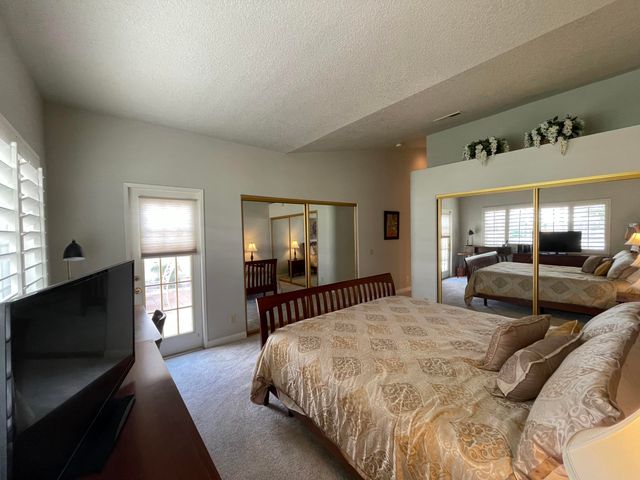 a spacious bedroom with a bed and a large window