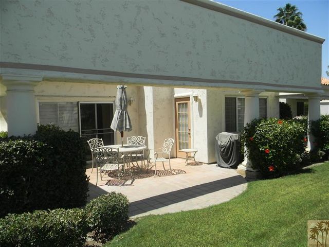 a patio with a table and chairs