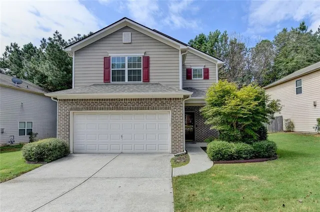 a front view of house with yard and green space
