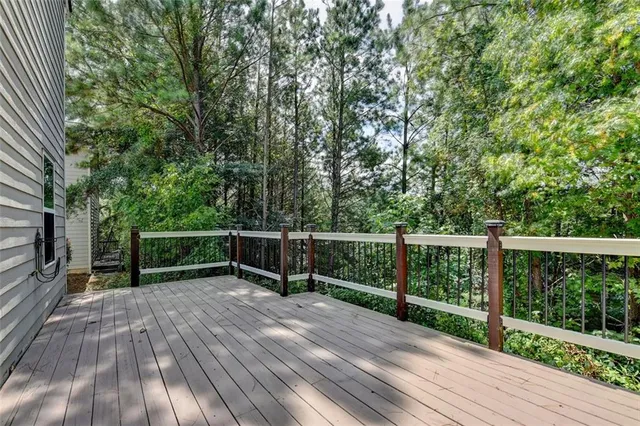 a view of balcony with wooden floor and fence