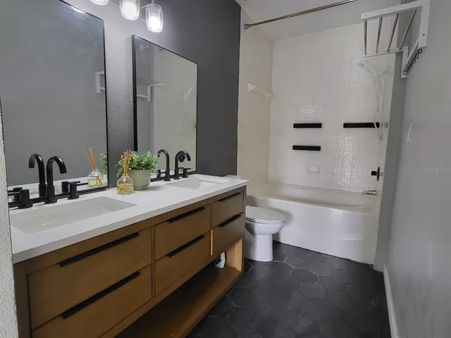 a front view of a house with a garden view