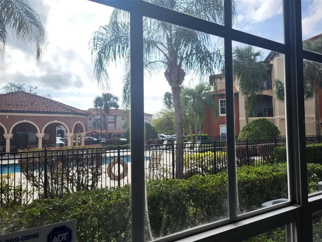 a view of a glass door with a yard from a window