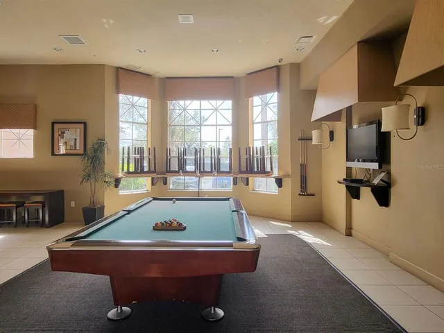 a front view of a house with a yard and potted plants