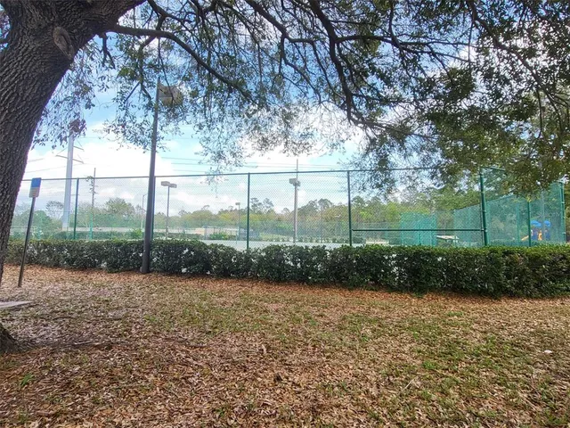 a living room filled with furniture a chandelier and a rug