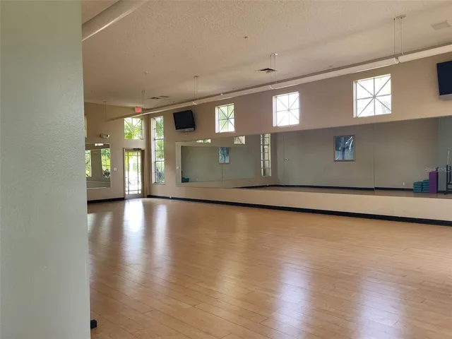 a kitchen with stainless steel appliances a stove a table and chairs in it