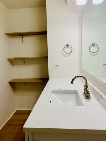 a bathroom with a sink and mirror